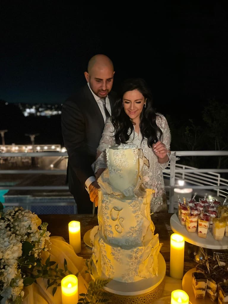 Sobia and Omar cutting a celebration cake