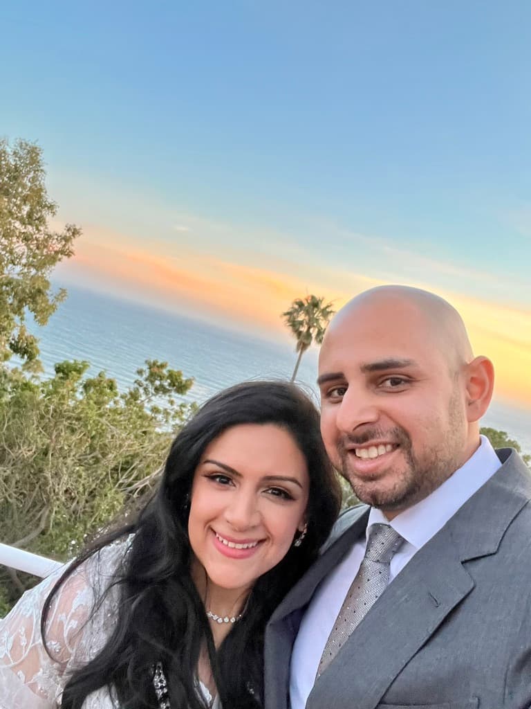 Sobia and Omar smiling at sunset